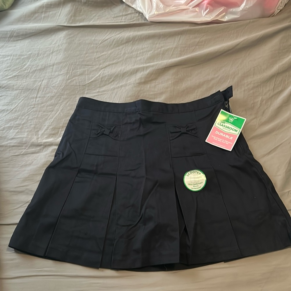 This is a navy blue, skort with bow pockets.
